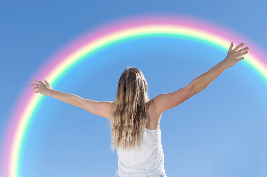 Free women appreciating rainbow image