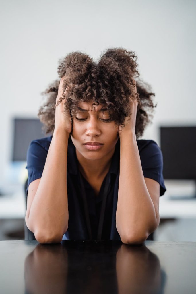 tired woman with hands in hair