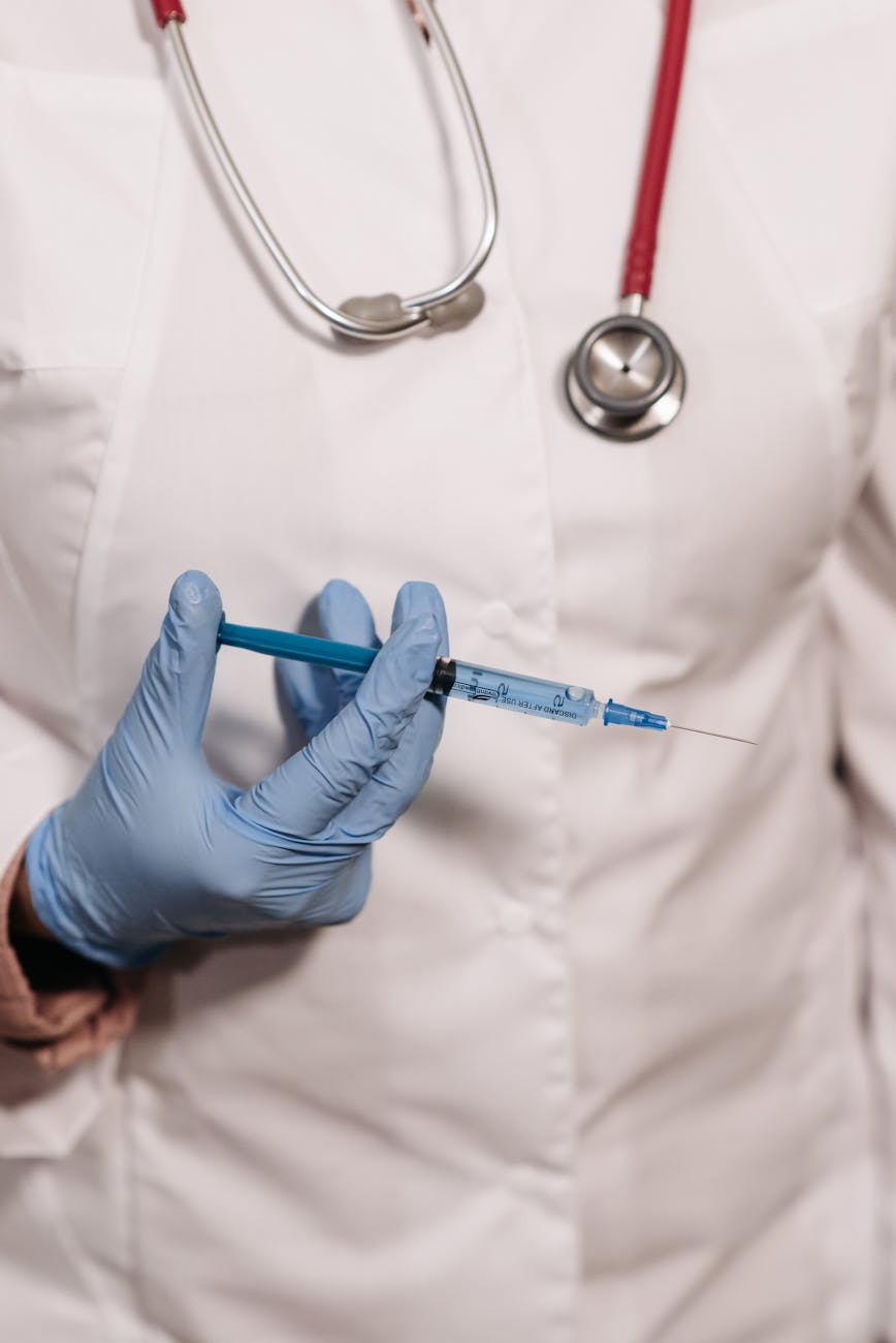 close up photo of a person holding a syringe