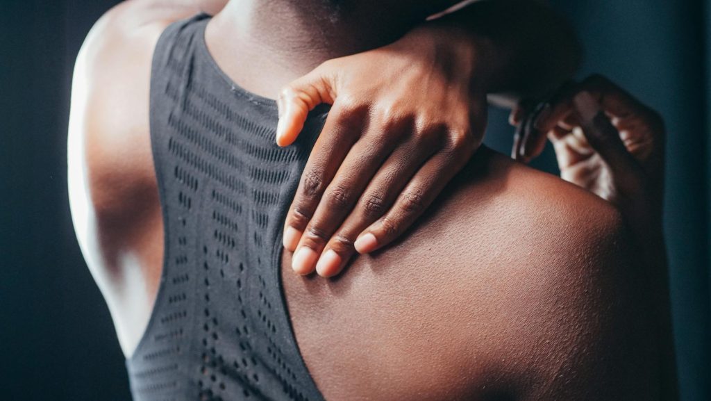 a woman holding his back