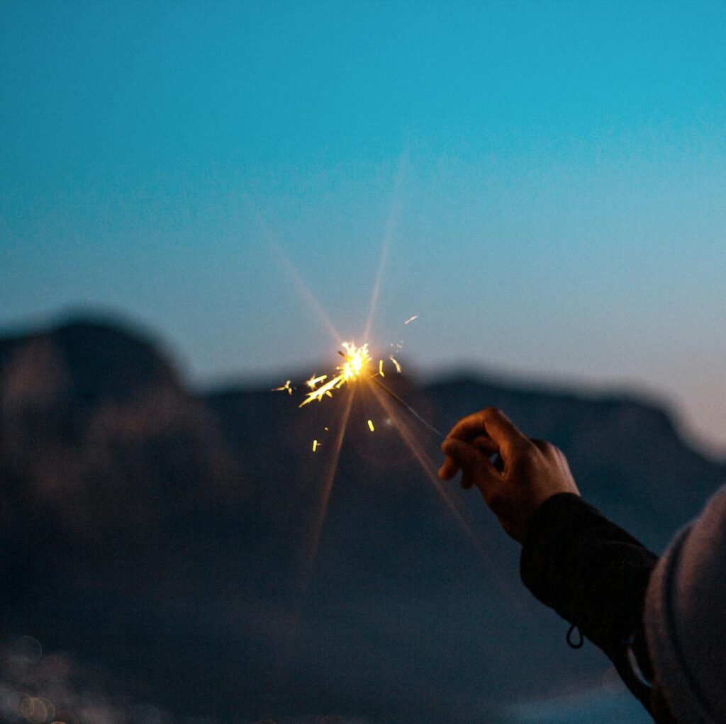 a lit flare light on hand
