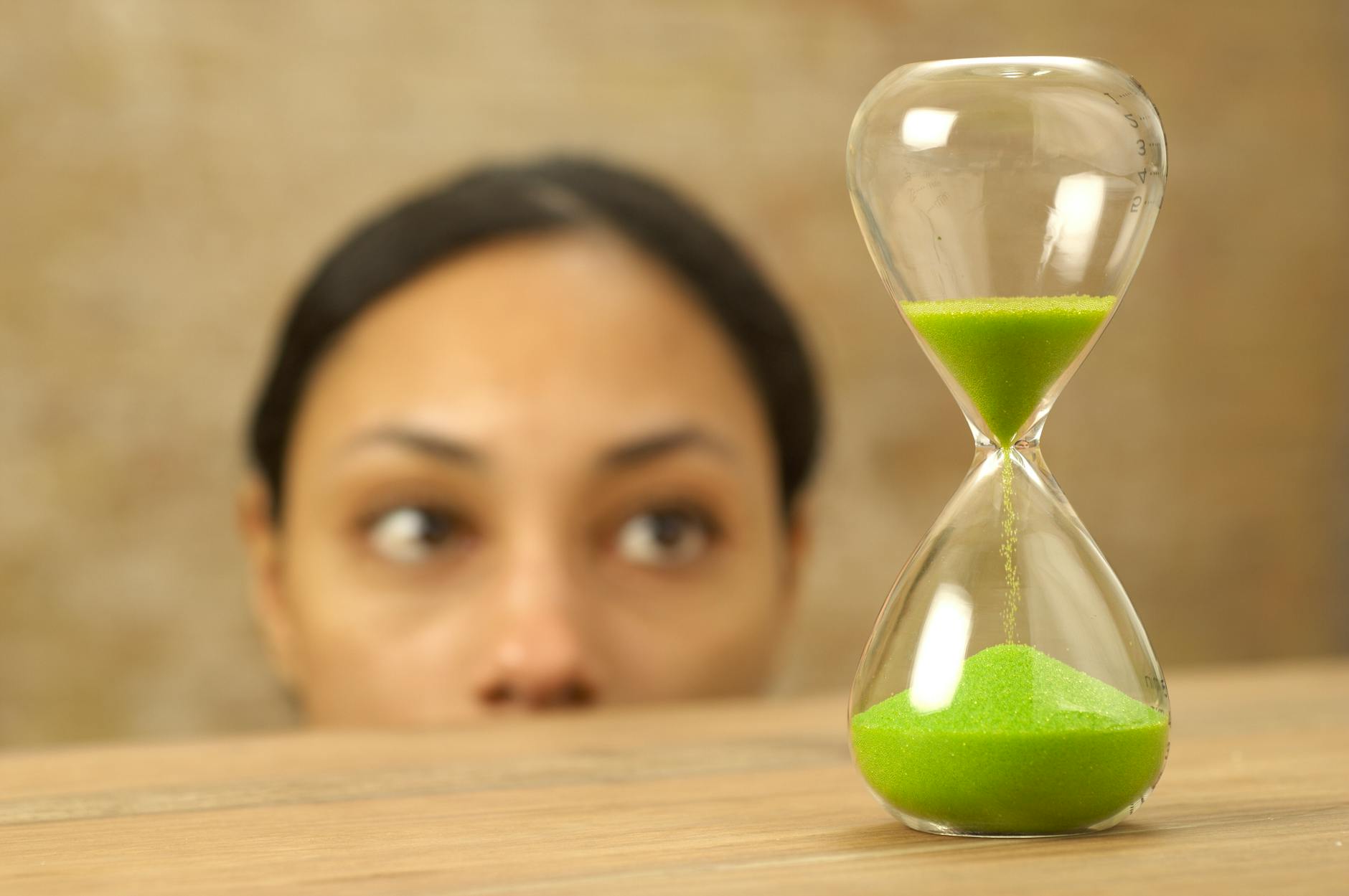 woman looking at hourglass