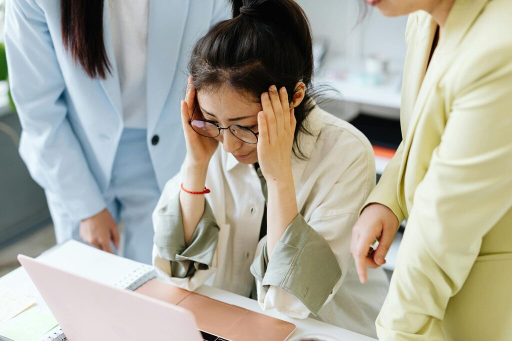worried woman looking into her laptop